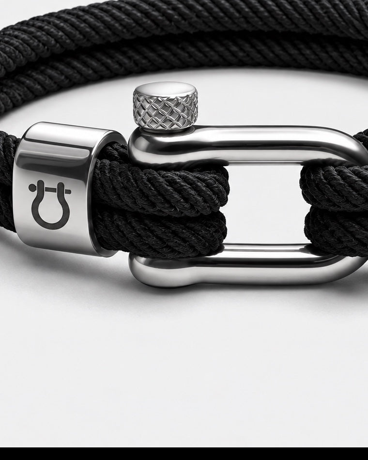 Close-up of the threaded steel pin, engraved bead and cord